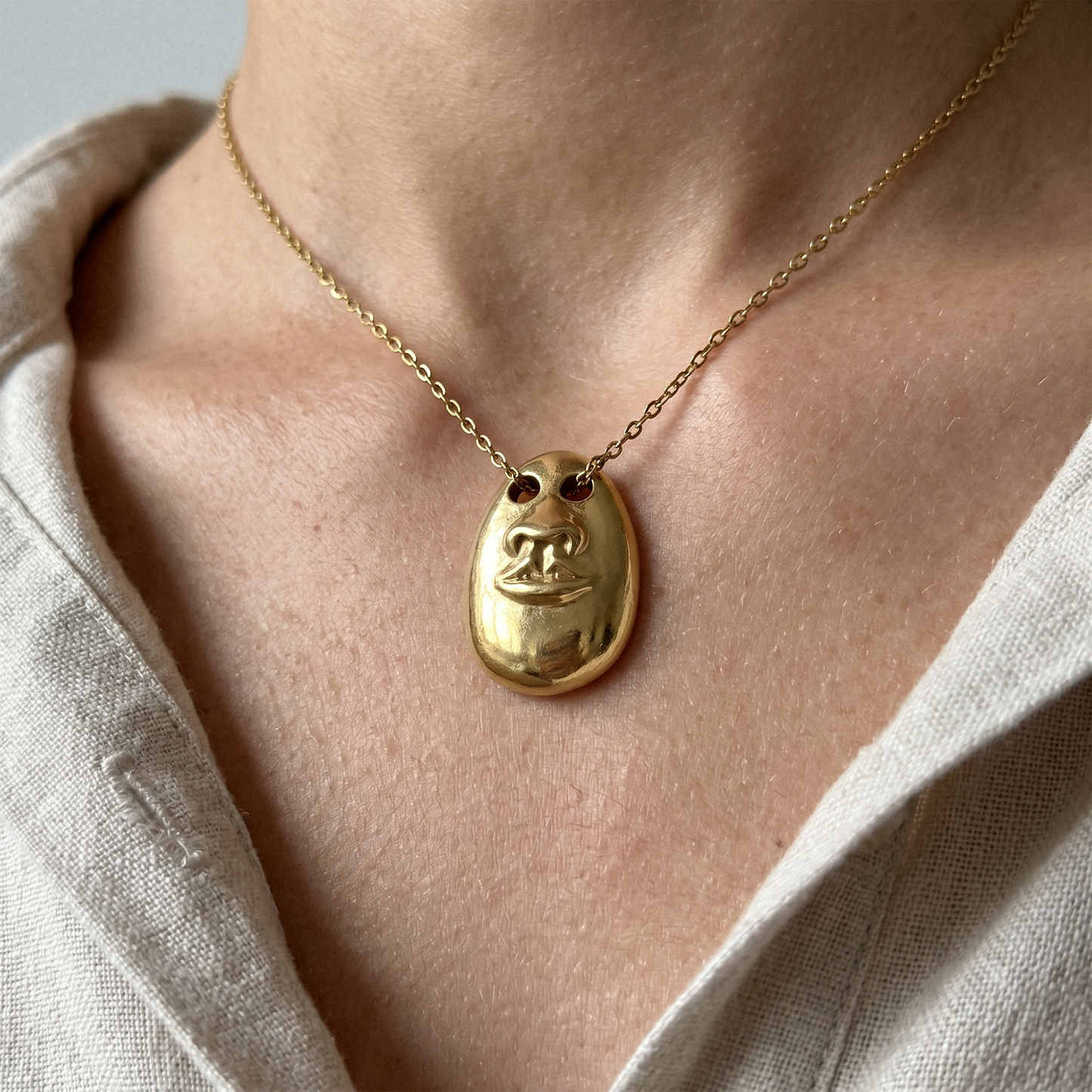 Close-up of the Hear No Evil Pendant Necklace showing the sculptural face pendant detail