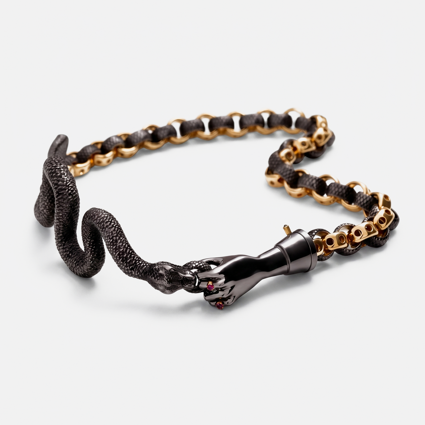 Gold and black snake chain bracelet with sculptural hand clasp, contemporary jewellery