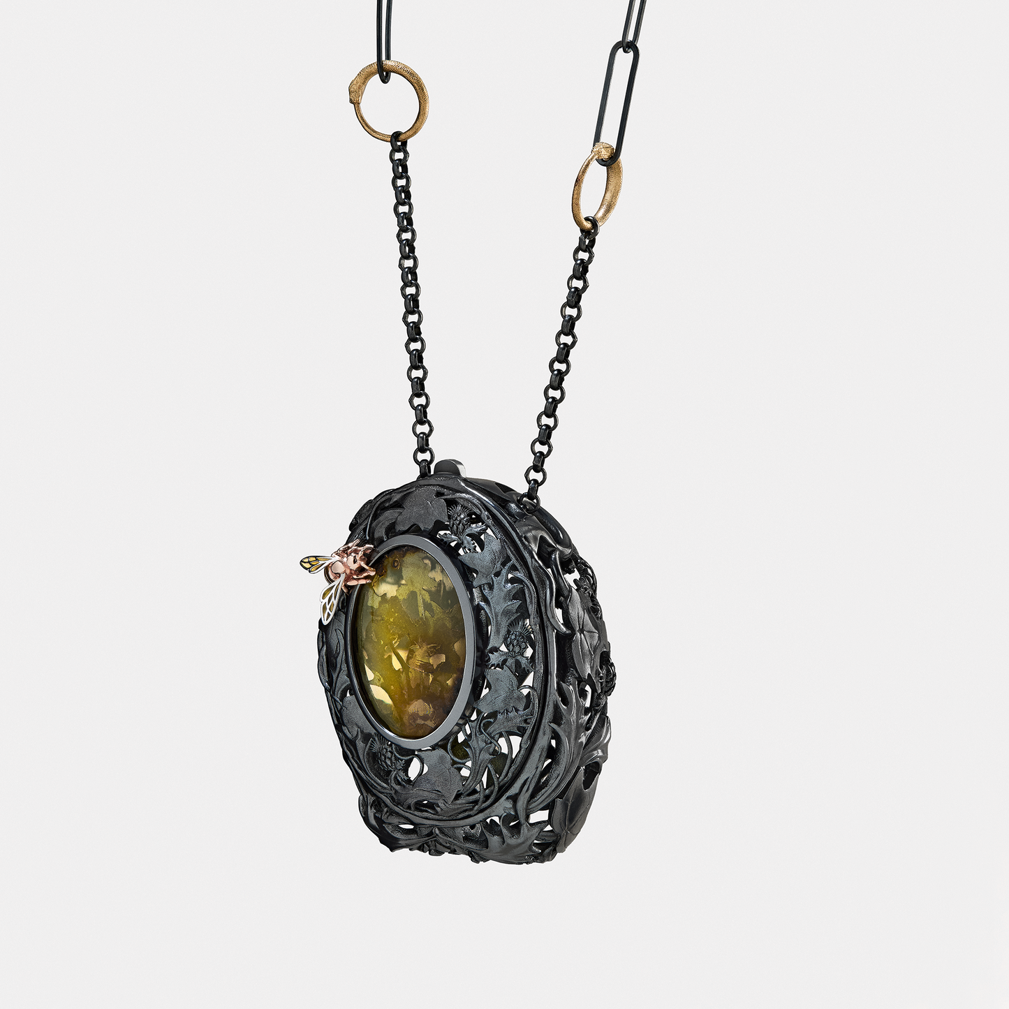 Black locket pendant necklace with green gemstone and insect detail, gothic designer jewellery