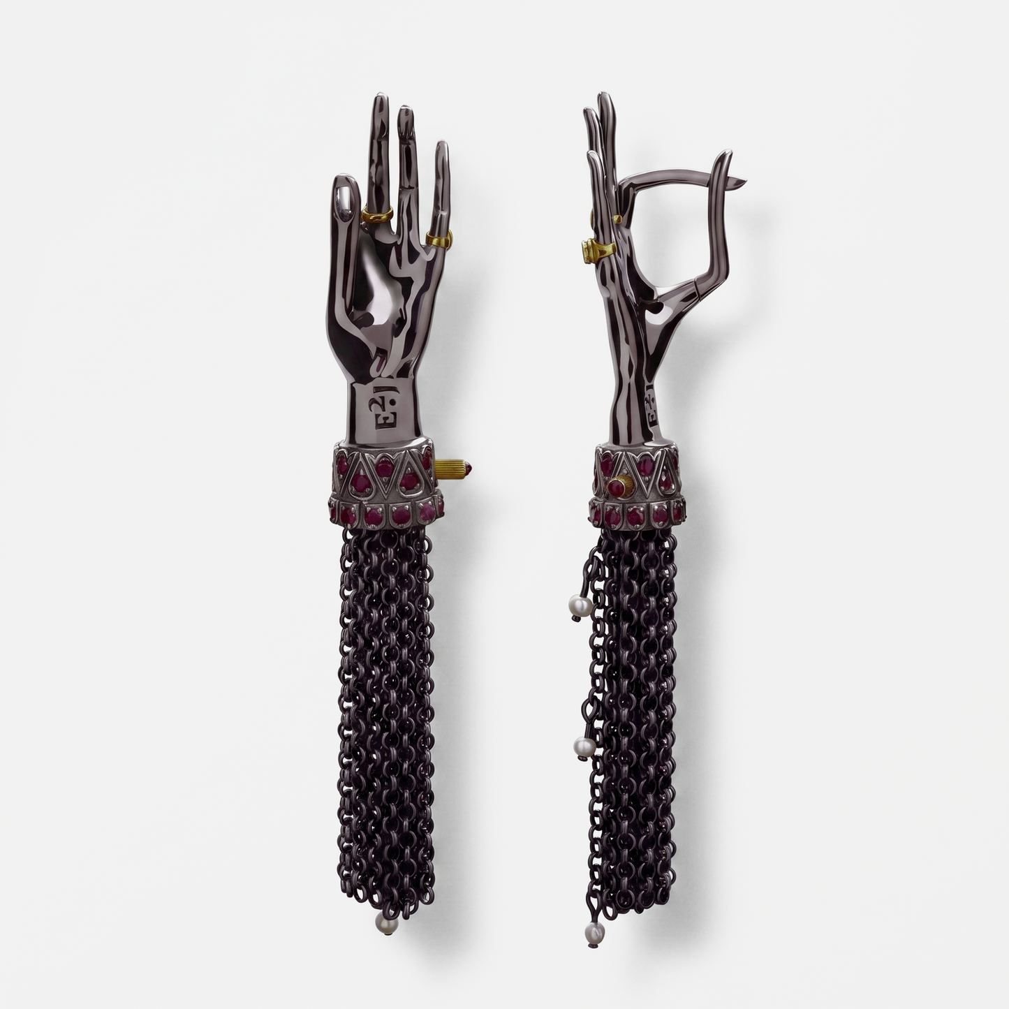 Back view of black sculptural hand earrings with chain tassels and gemstone accents, modern designer jewellery