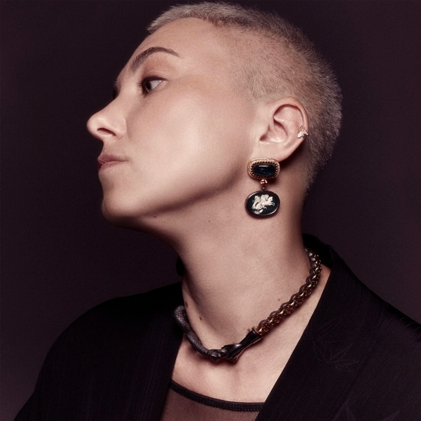 Model wearing statement snake necklace and earrings, contemporary designer jewellery UK