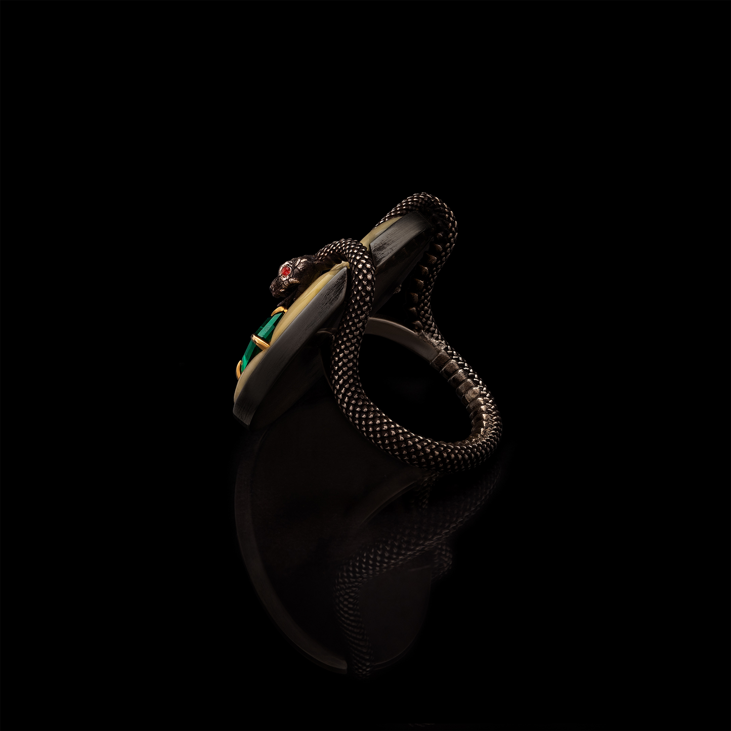 Sculptural designer ring with snake motif and emerald gemstone, bold contemporary jewellery