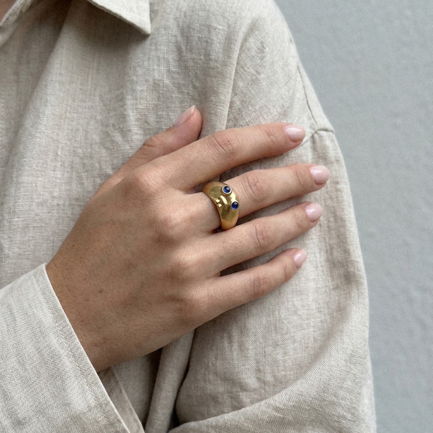 Baby’s Got Blue Eyes Ring worn on hand in 18k gold with sapphires by Charlotte Le Hardy
