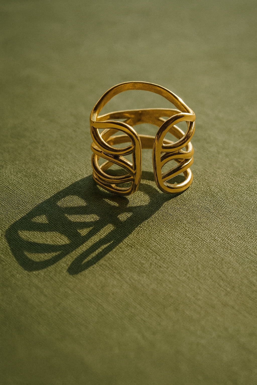 Gold ring on a green textured surface