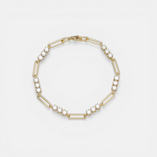 A gold link bracelet featuring alternating elongated oval links and smaller chain links embellished with clear round gemstones, displayed on a clean white background.