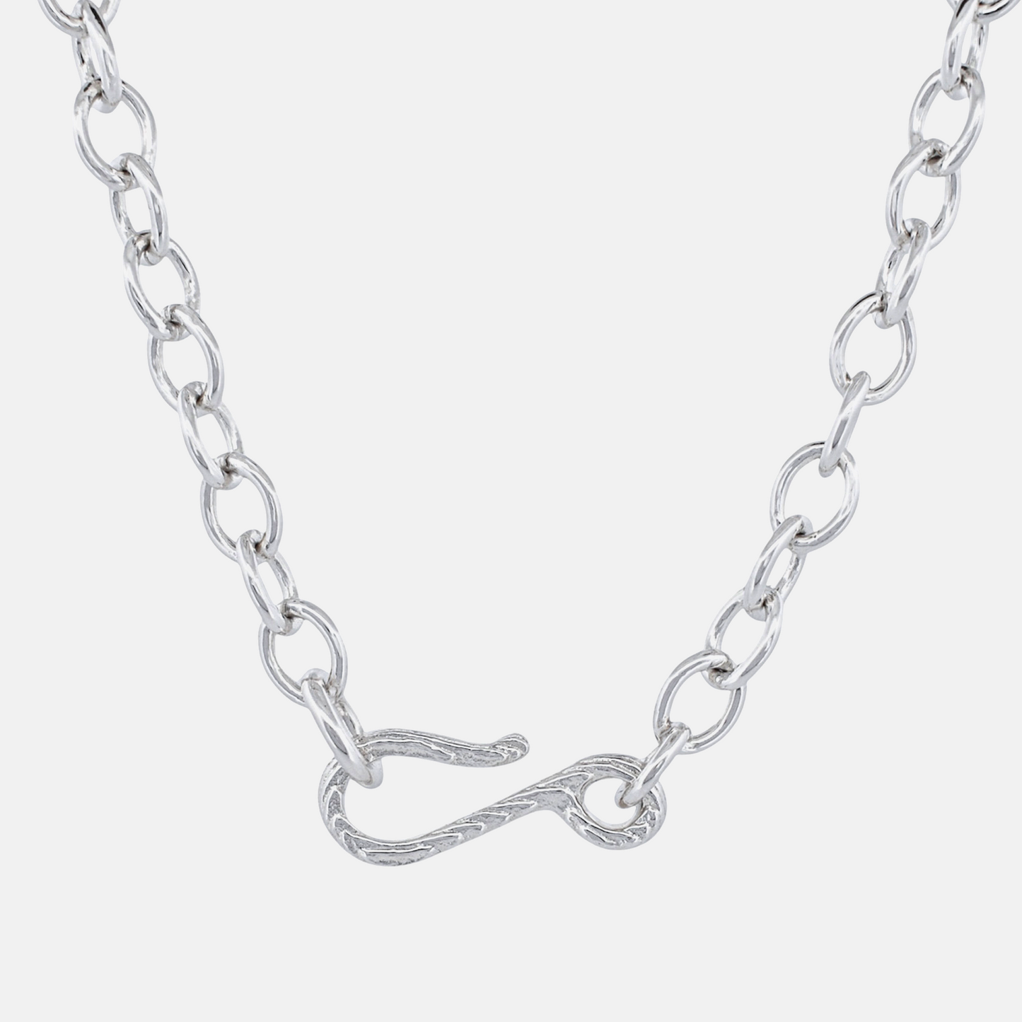 A silver chain necklace featuring a unique twisted infinity symbol clasp, shown against a light gray background.