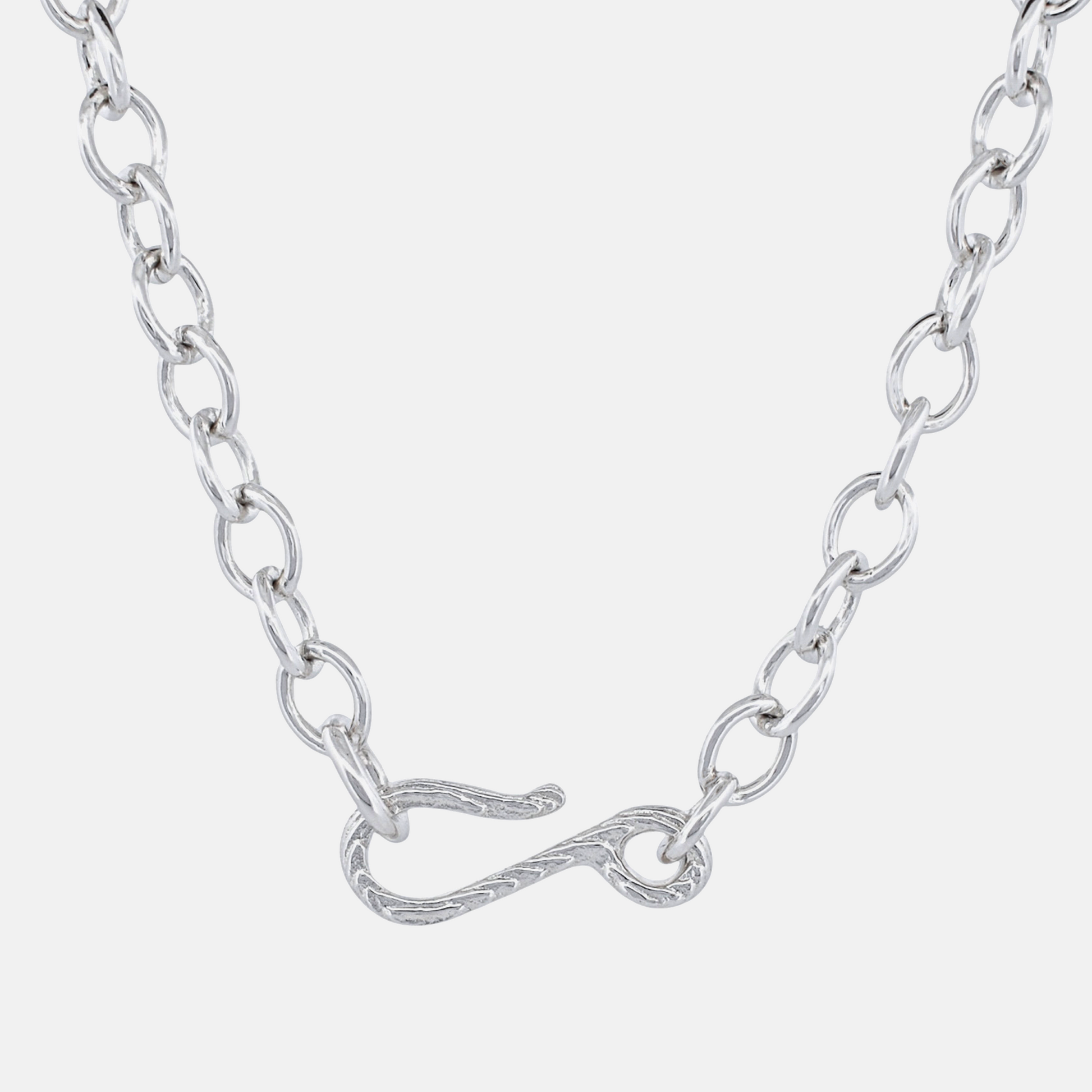 A silver chain necklace featuring a unique twisted infinity symbol clasp, shown against a light gray background.