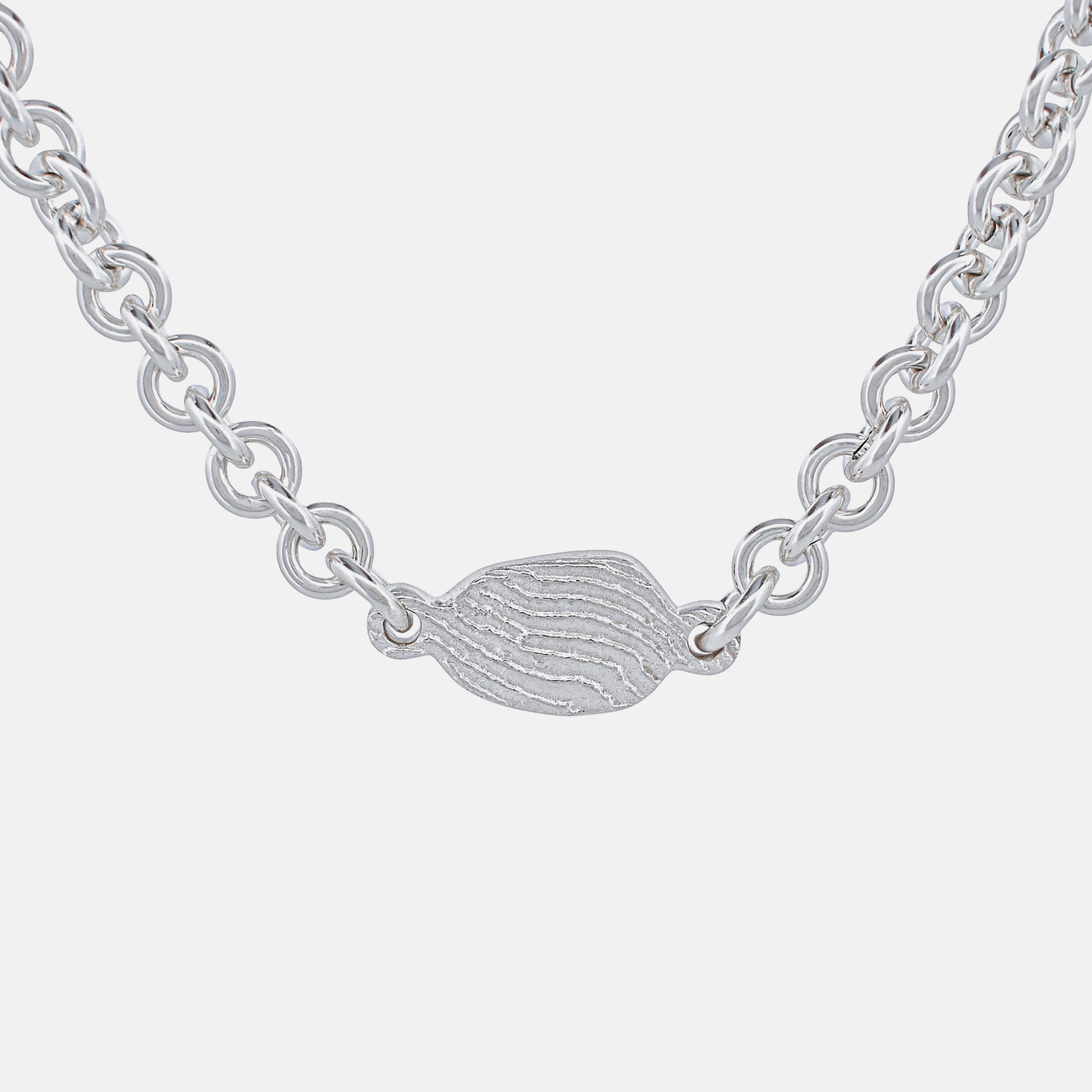 Silver chain necklace with a small, detailed pendant on a white background