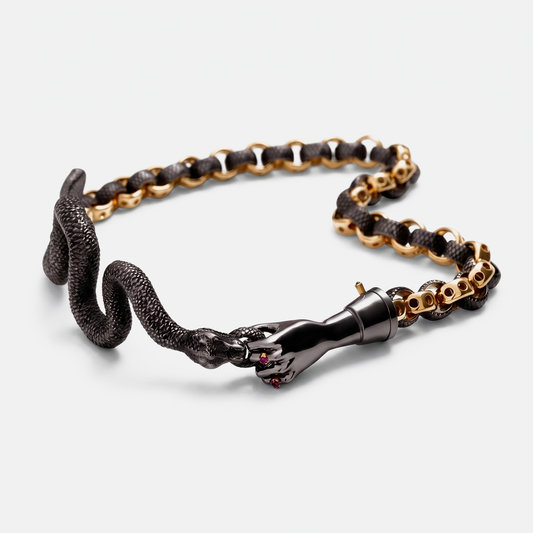 Gold and black snake chain bracelet with sculptural hand clasp, contemporary jewellery