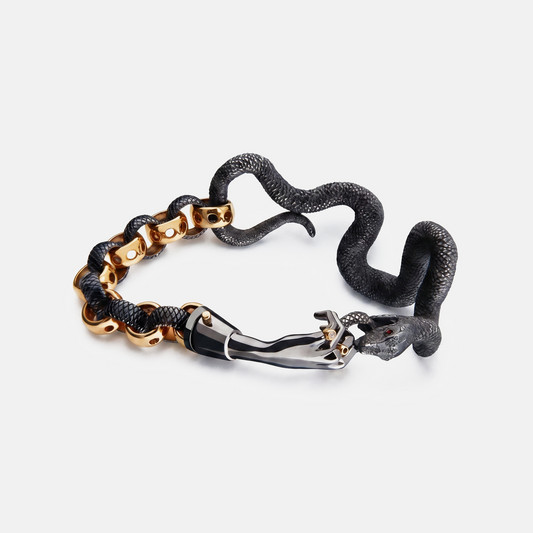 Black and gold snake bracelet with sculptural hand clasp, contemporary designer jewellery UK