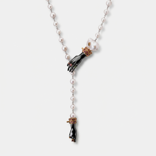 Pearl necklace with sculptural black hand pendant, baroque pearl and gold ruby details, contemporary designer jewellery