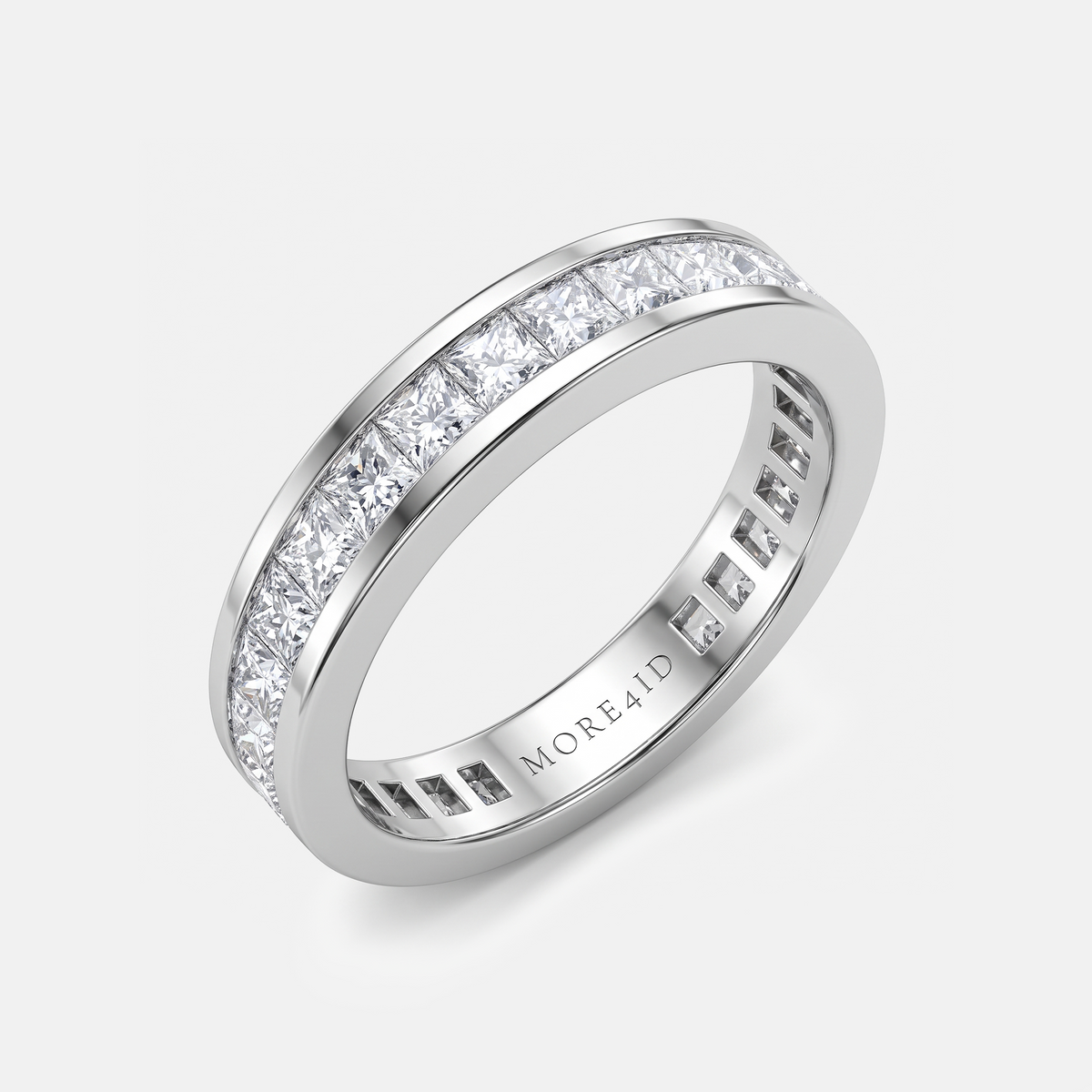 A silver-tone eternity ring with a channel-set row of clear round-cut diamonds on one side and a beveled edge on the other, shown on a light gray background. The inside of the band is engraved with the brand name 'MORE41D'.