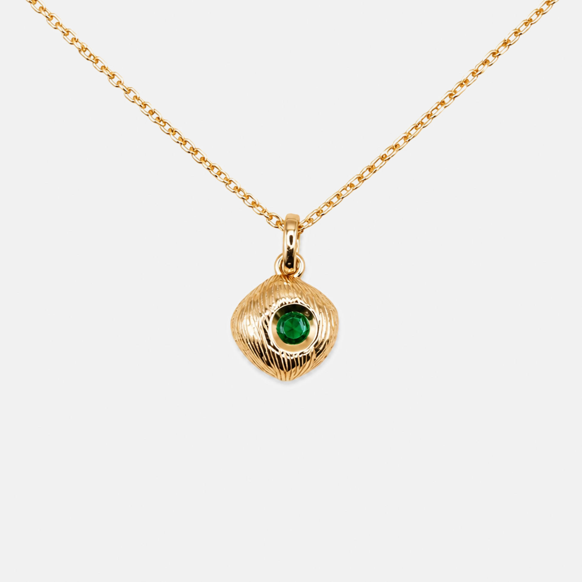 Silver necklace with a green gemstone pendant on a white background
