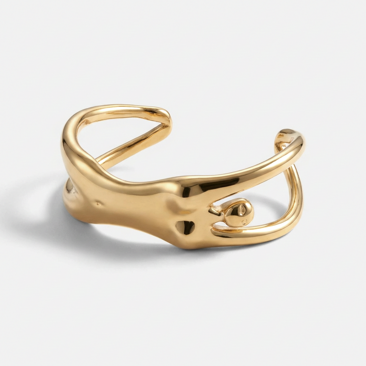 Gold open ring on a light gray background