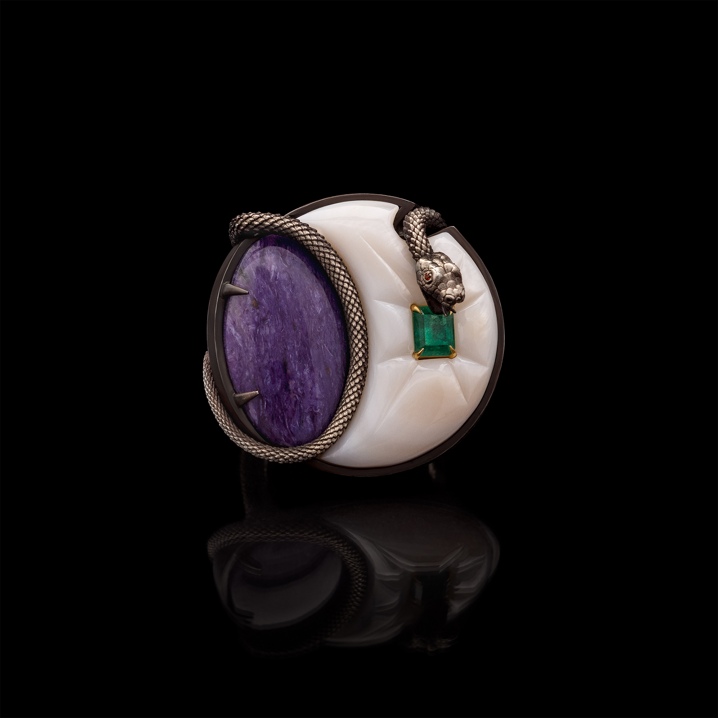 Luxury statement ring with purple stone, emerald accent and snake design on black background, artistic jewellery piece