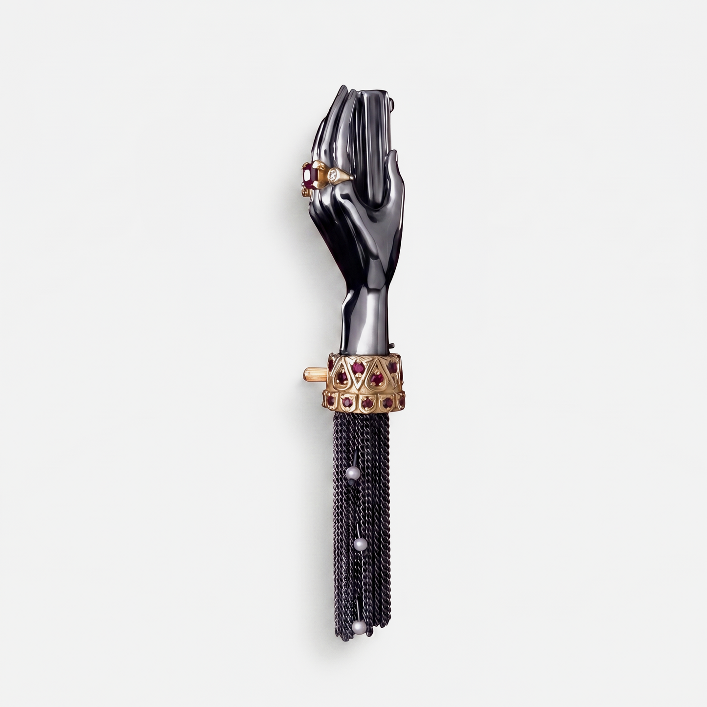 Black hand brooch with gold cuff, ruby stones and chain tassel, unique designer jewellery piece