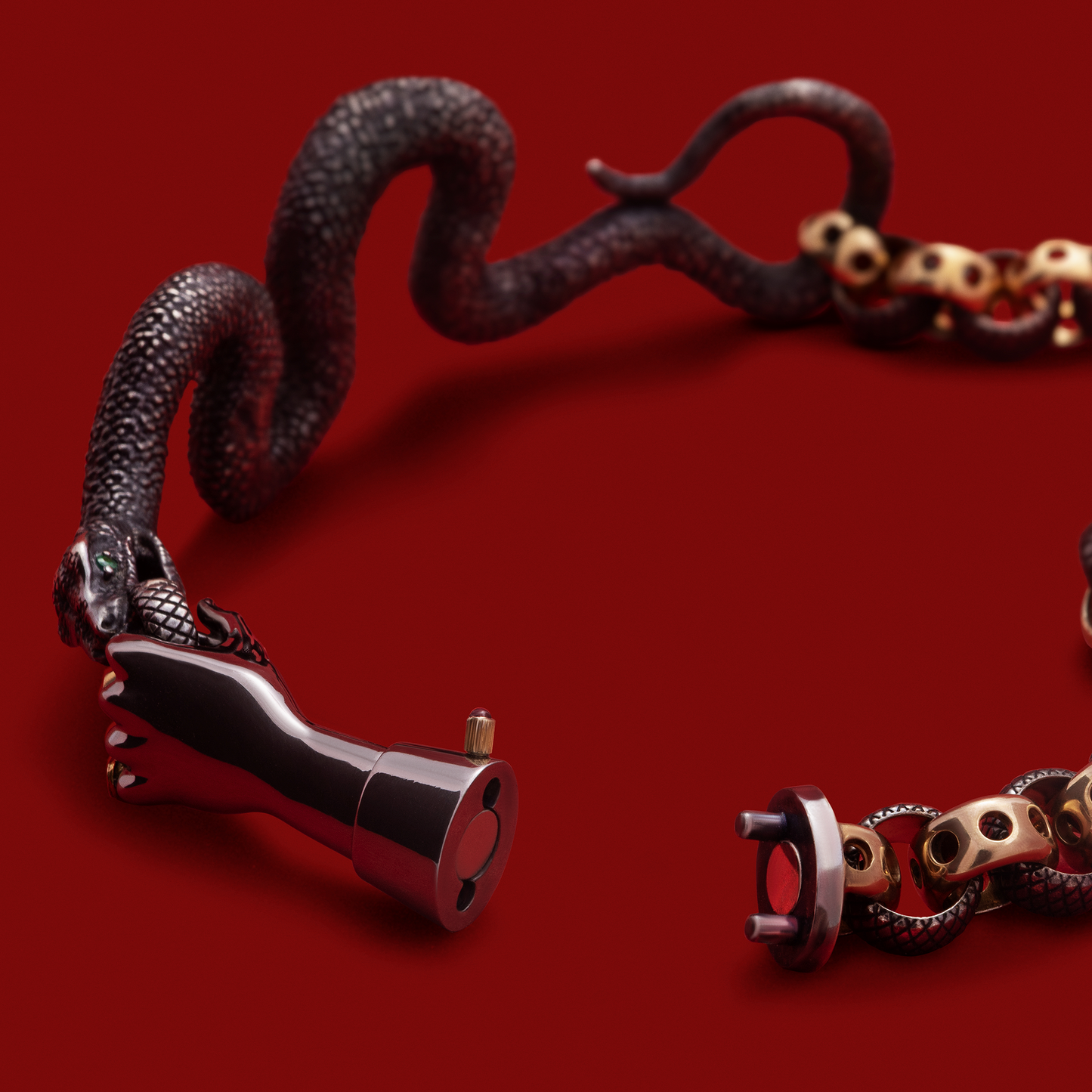 Snake bracelet with hand clasp in black and gold, statement designer jewellery UK