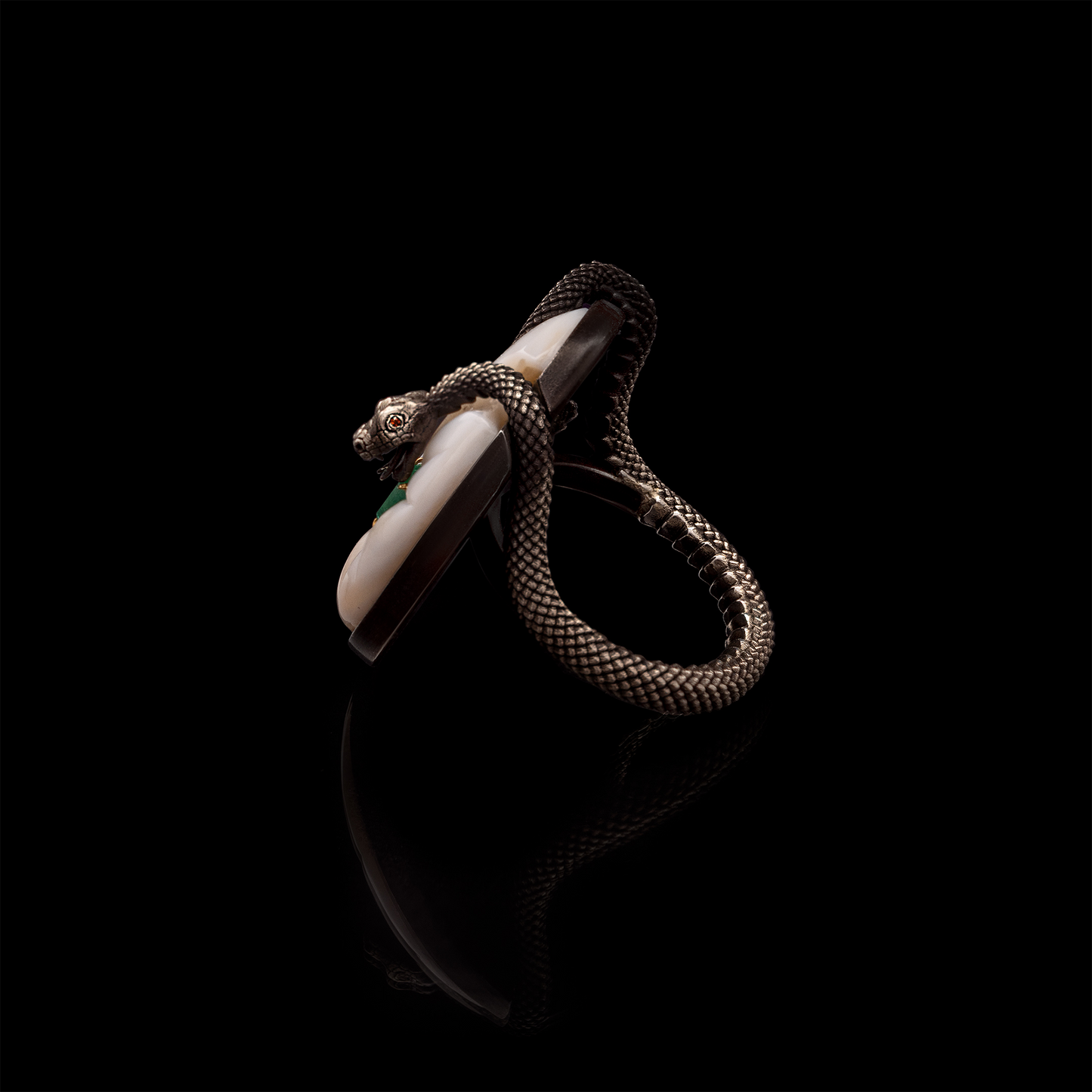 Sculptural designer ring with snake motif and emerald gemstone, bold contemporary jewellery design