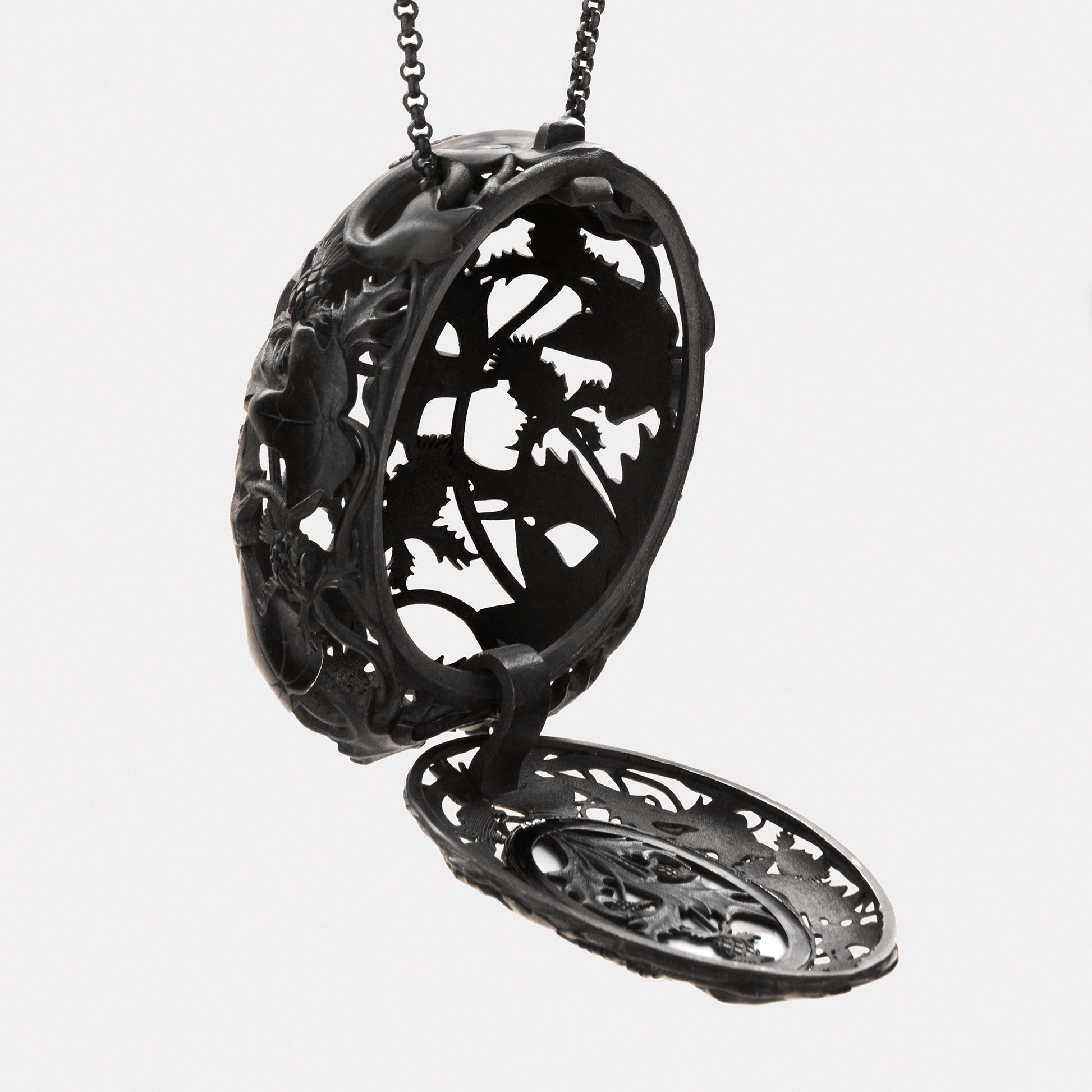 Open black locket pendant with intricate filigree interior, statement gothic jewellery necklace