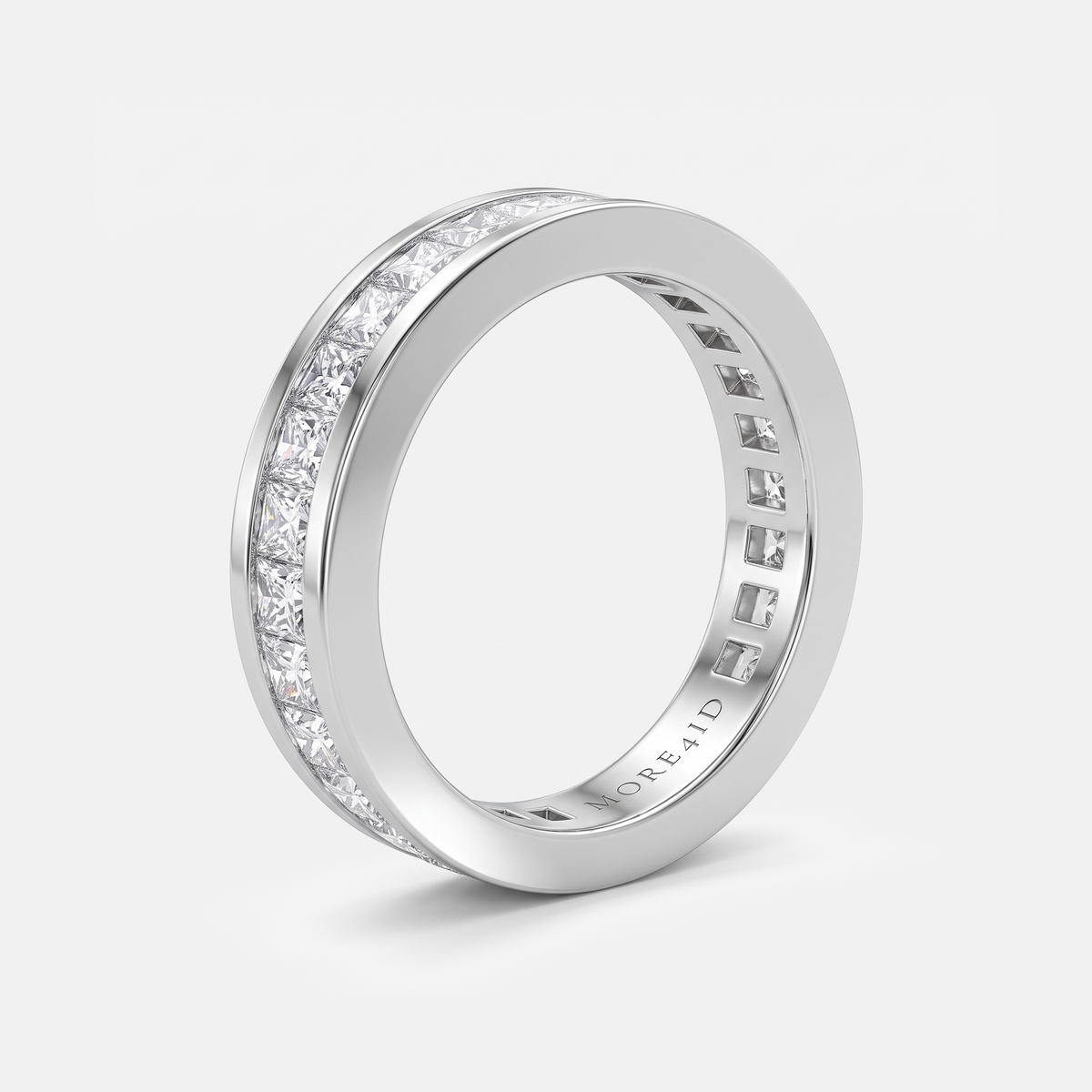 A silver-tone eternity band ring featuring a channel-set row of clear round-cut stones on one side, shown on a light gray background.