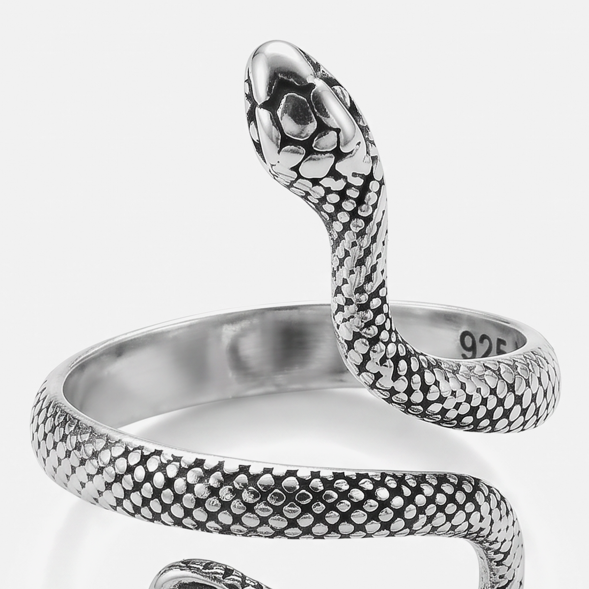 A sterling silver snake wrap ring with a highly detailed, textured scale pattern and polished finish, shown on a clean light gray background. The inner band is stamped with '925' silver purity.
