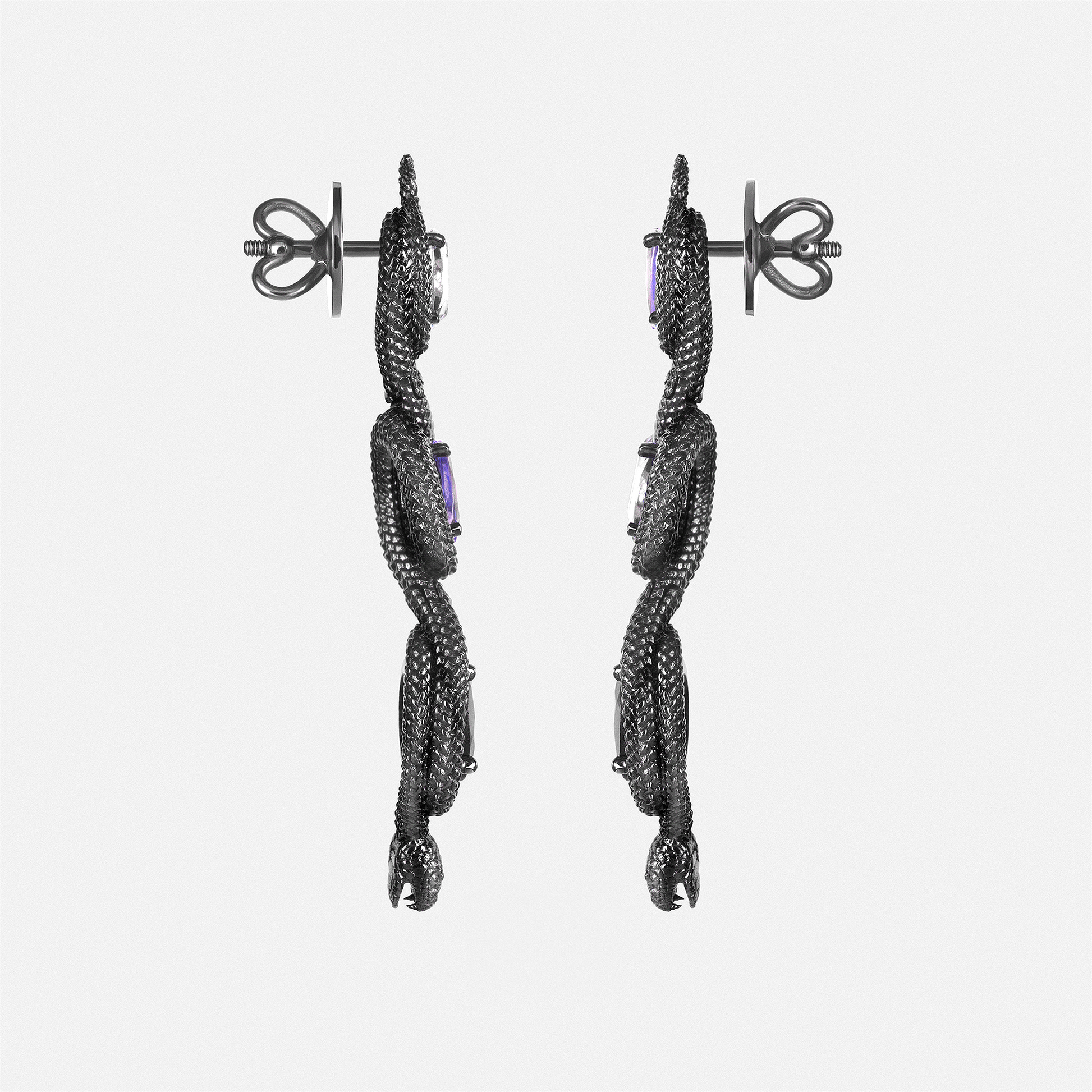 Side view of snake-inspired dangling earrings with oval gemstones, contemporary sculptural jewellery