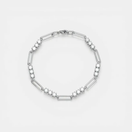 A silver-toned link bracelet featuring alternating elongated oval links and clusters of small round clear stones, displayed on a clean white background.
