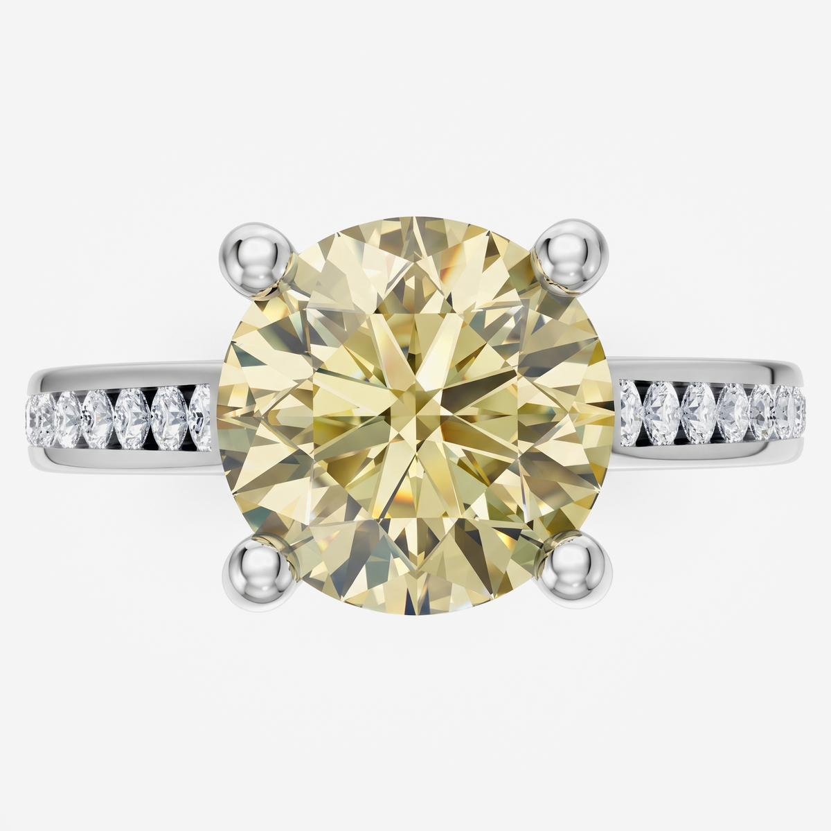 A round yellow diamond engagement ring with a silver-toned band featuring pavé-set diamonds on the shoulders, shown against a light gray background.