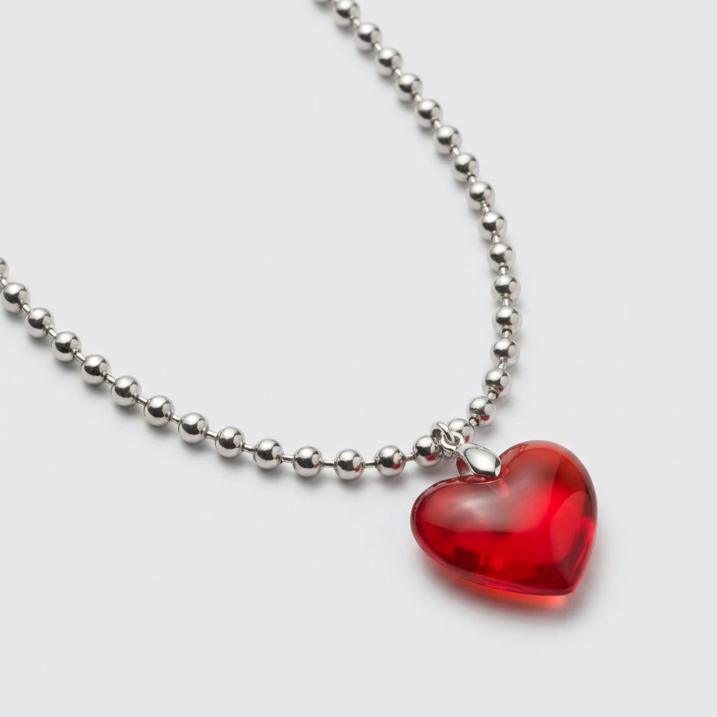 Necklace with a red heart pendant on a white background