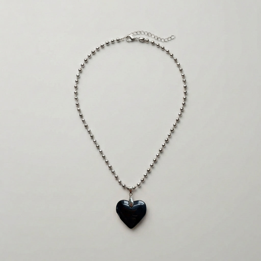 Necklace with a heart-shaped pendant on a light gray background