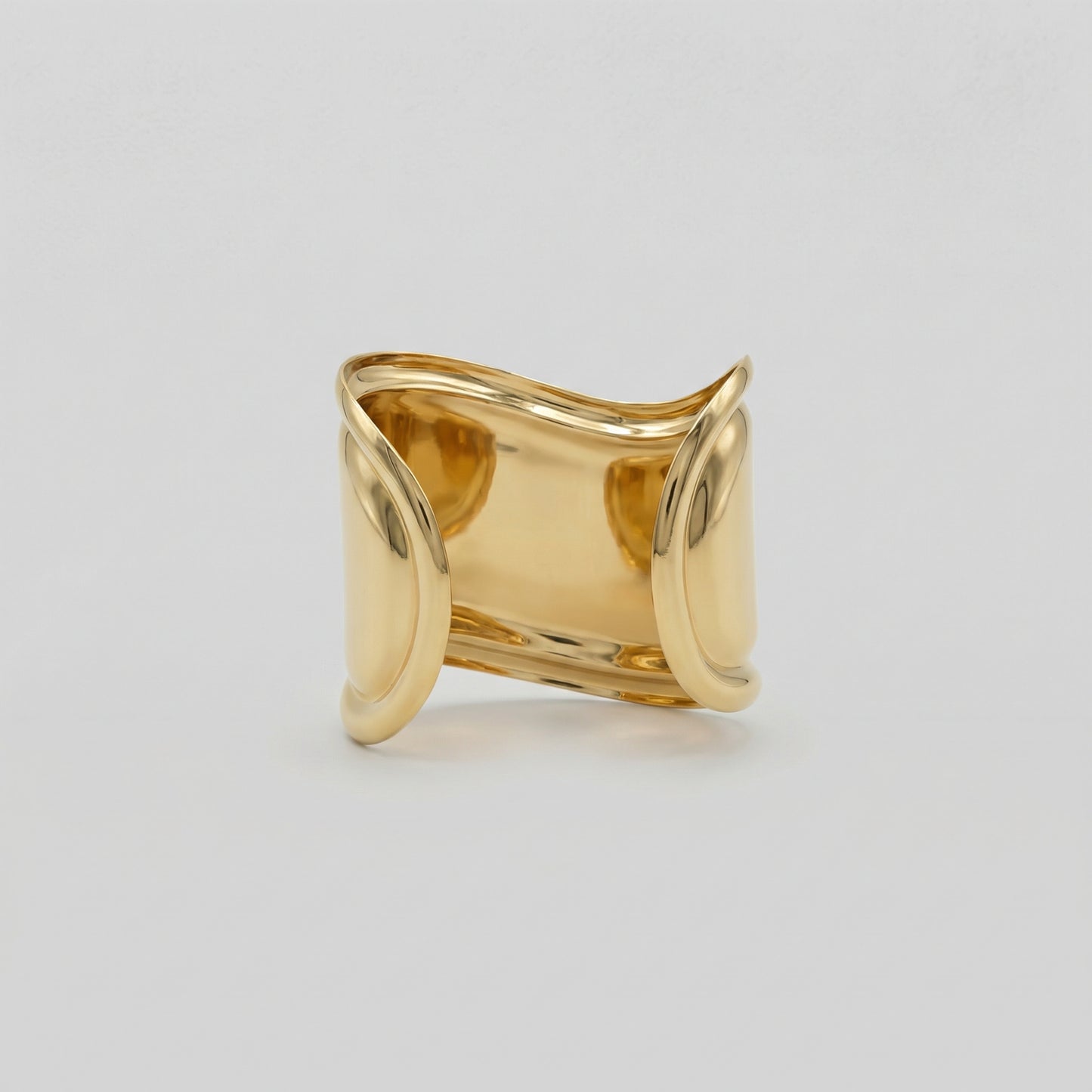 Gold bracelet displayed on a light gray background