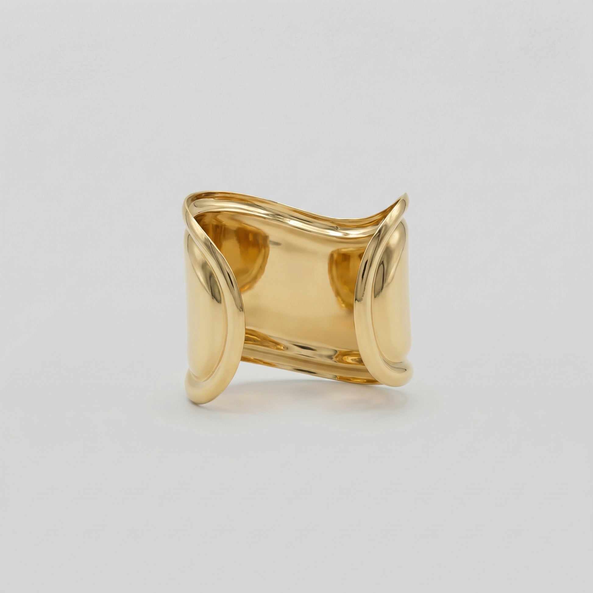 Gold bracelet displayed on a light gray background