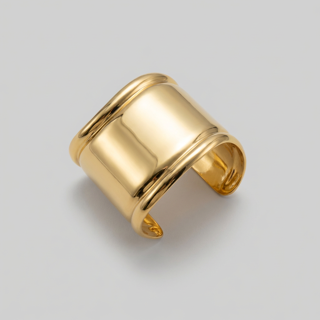 Gold bangle on a light gray background