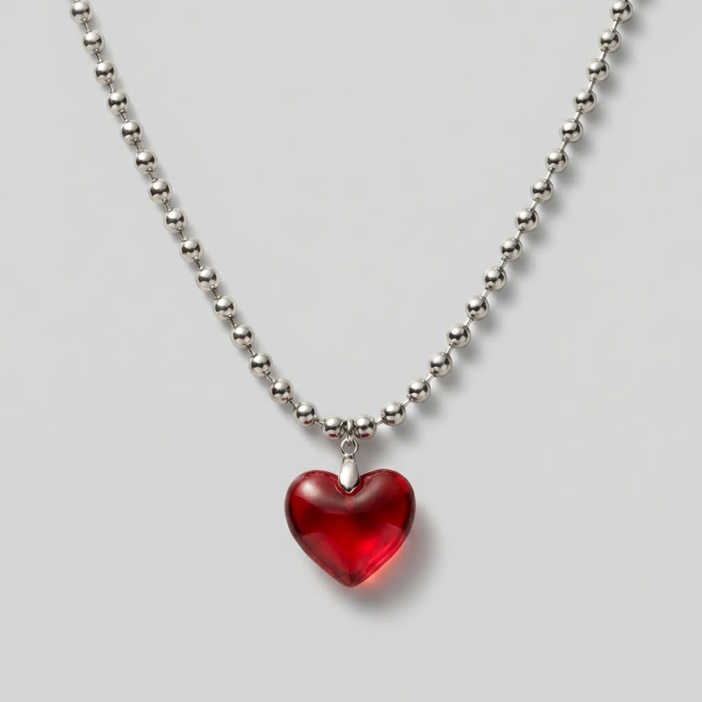 Necklace with a red heart pendant on a light gray background