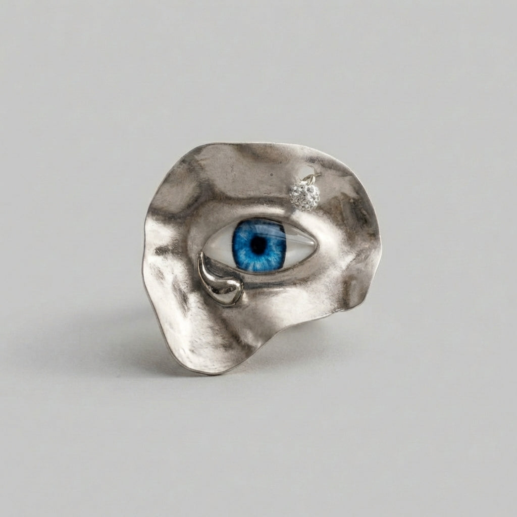 Silver ring with a blue gemstone on a gray background