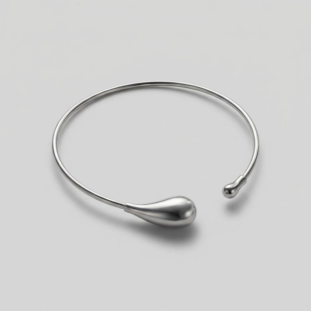 Silver necklace on a light gray background