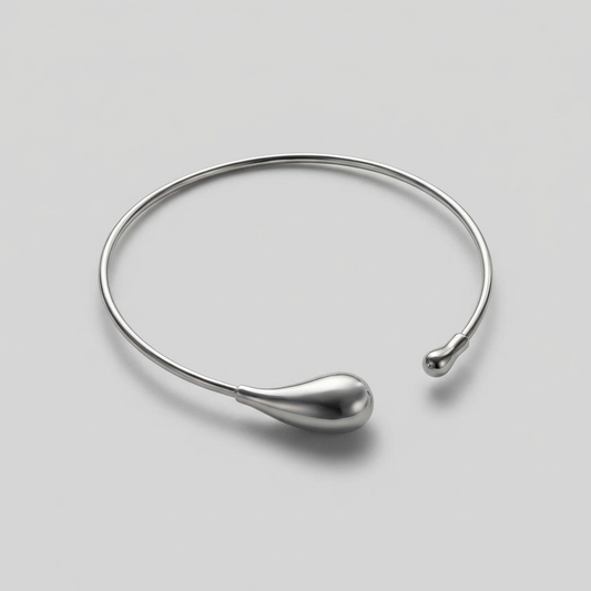 Silver necklace on a light gray background