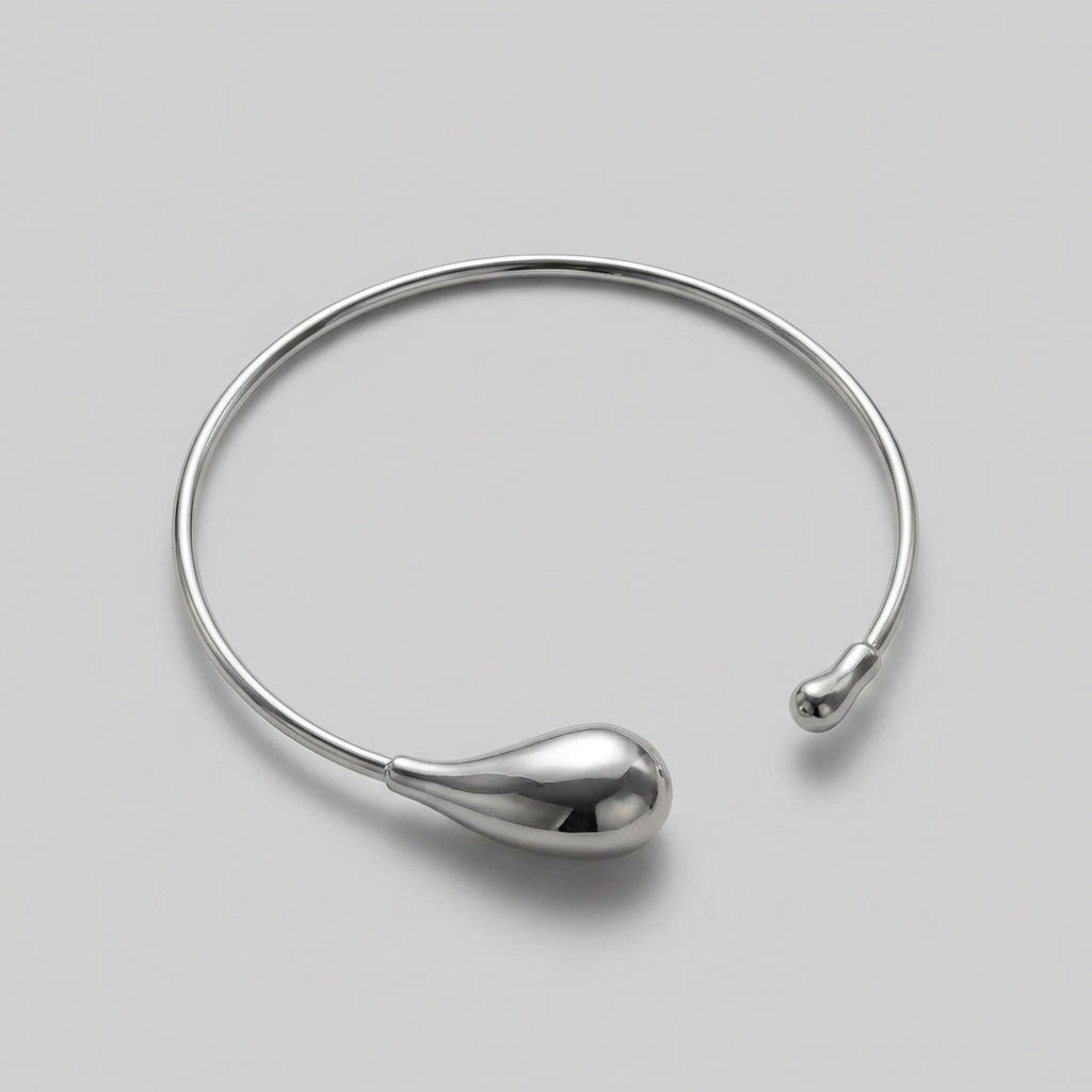 Silver necklace on a light gray background