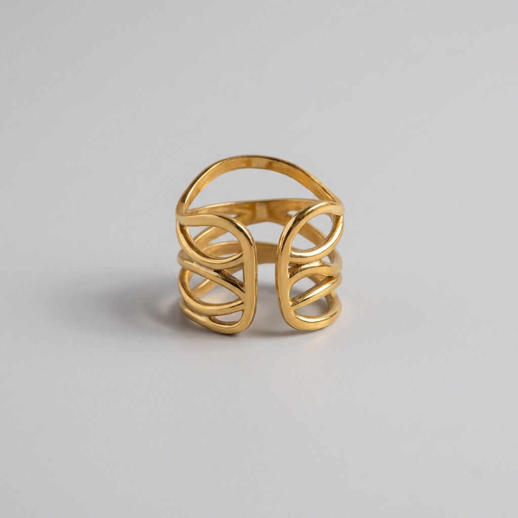 Gold ring with a geometric design on a light gray background