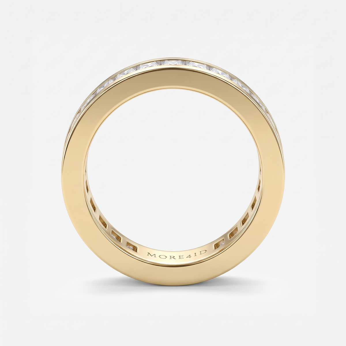 A gold eternity ring with a channel-set diamond band, shown from a top-down perspective on a light gray background. The brand name 'MORE412' is engraved on the inside of the band.