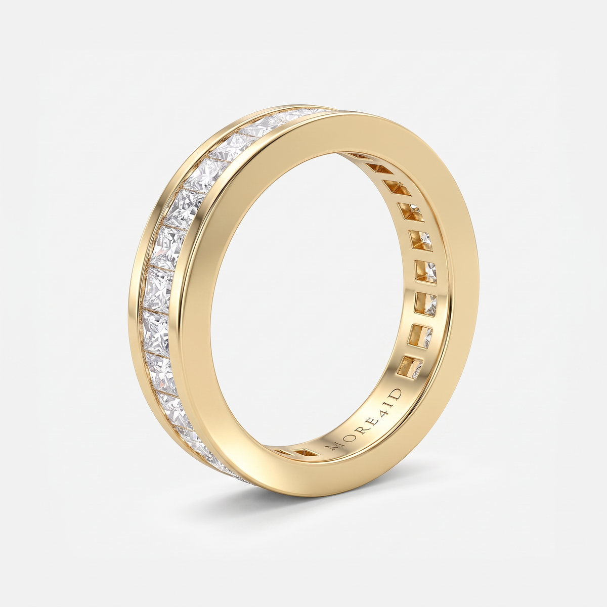 A yellow gold eternity ring featuring a continuous channel setting of clear rectangular-cut stones on one side, shown on a clean light gray background.